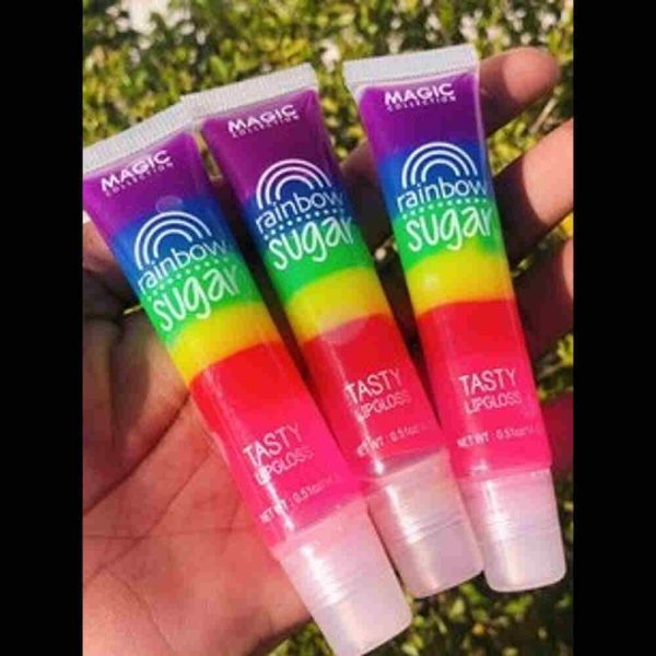 three Magic rainbow sugar lip balm in hand